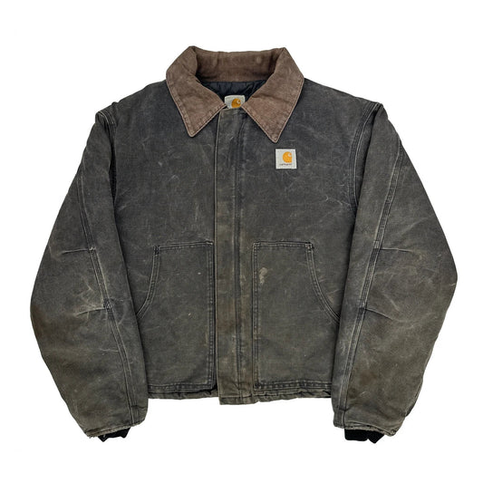 Worn denim jacket with Carhartt logo on a white background